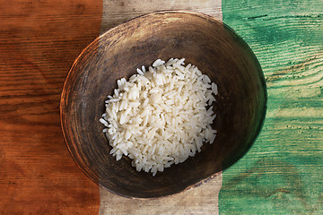 Image showing Poverty concept, bowl of rice with Ivory Coast flag      