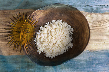 Image showing Poverty concept, bowl of rice with Argentine flag      