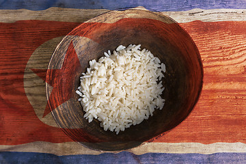 Image showing Poverty concept, bowl of rice with North Korea flag      