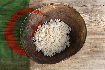 Image showing Poverty concept, bowl of rice with Algeria flag      