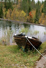 Image showing Tarred tethered boat