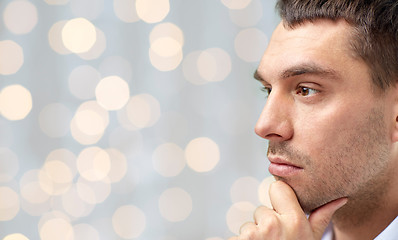 Image showing close up of male face over lights background