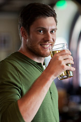 Image showing happy man drinking beer at bar or pub