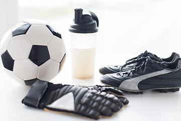 Image showing close up of football boots, gloves and bottle