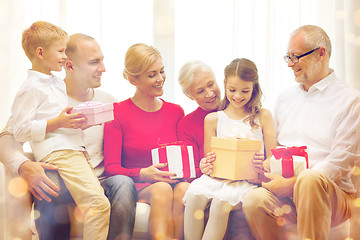 Image showing smiling family with gifts at home