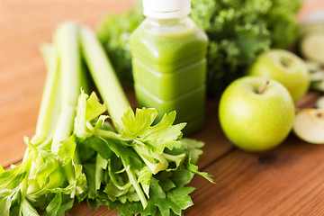 Image showing close up of bottle with green juice and vegetables