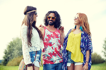 Image showing smiling young hippie friends talking outdoors