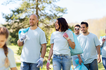 Image showing group of volunteers with garbage bags in park