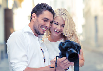 Image showing smiling couple with photo camera