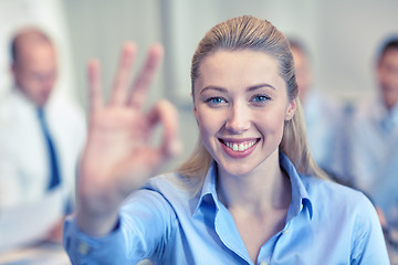 Image showing group of smiling businesspeople meeting in office