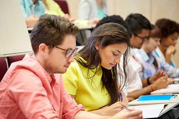 Image showing group of international students writing at lecture