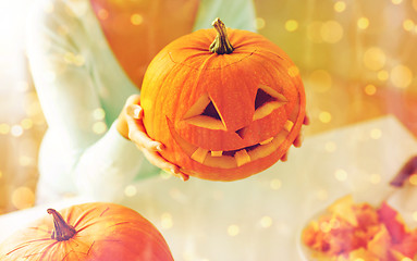 Image showing close up of woman with pumpkins at home