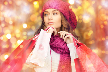 Image showing happy woman in winter clothes with shopping bags