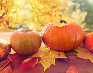 Image showing close up of pumpkins on wooden table outdoors