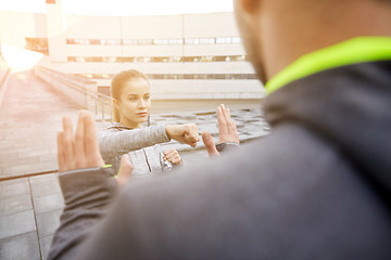 Image showing woman with trainer working out self defense strike