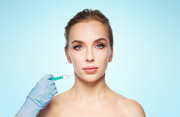 Image showing woman face and hand with syringe making injection