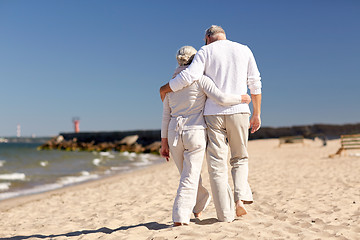 Image showing happy senior couple hugging on summer beach