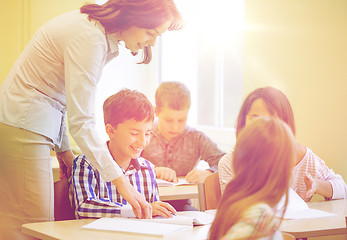 Image showing group of school kids writing test in classroom