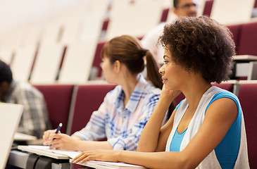 Image showing group of students talking in lecture hall