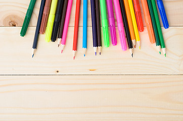 Image showing Colored pencils on a wooden board