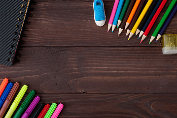 Image showing School supplies on a wooden table