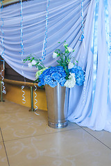 Image showing Bouquet of white and blue flower in metal vase