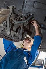 Image showing Female Mechanic Repairing Suspension System Of Car In Garage