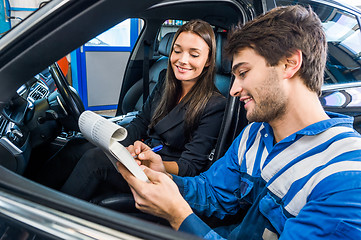 Image showing Car Mechanic With Customer Going Through Maintenance Checklist