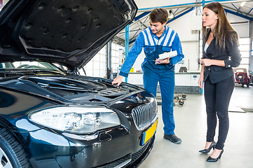 Image showing Mechanic Talking To Female Customer About Car Engine