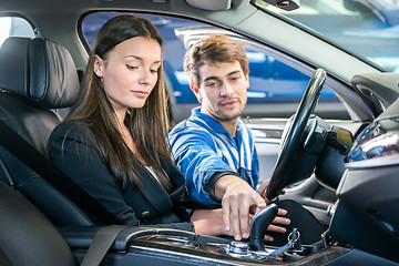 Image showing Woman Looking At Mechanic Checking Gearshift Of Car