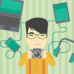 Image showing Young man surrounded with his gadgets.