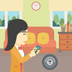 Image showing Woman controlling vacuum cleaner with smartphone.