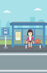 Image showing Woman waiting for bus at the bus stop.