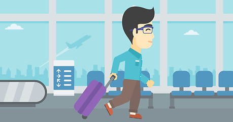 Image showing Man walking with suitcase at the airport.