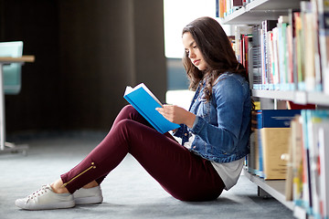 Image showing high school student girl reading book at library