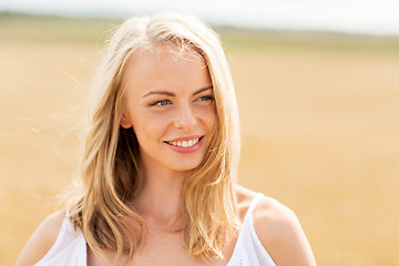 Image showing smiling young woman in white on cereal field