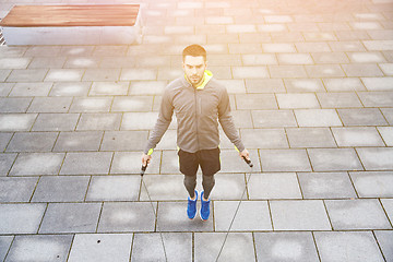 Image showing man exercising with jump-rope outdoors