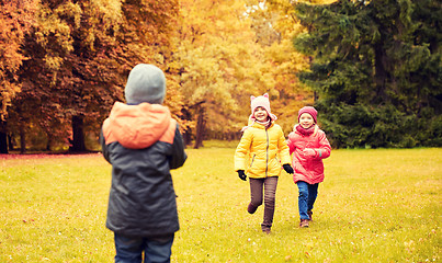 Image showing group of happy little kids running outdoors