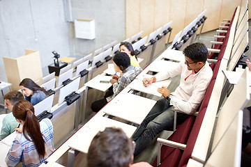 Image showing group of students with notebooks in lecture hall