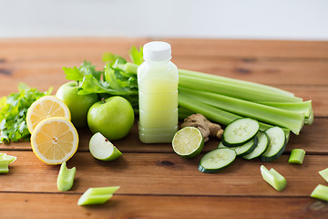 Image showing close up of bottle with green juice and vegetables