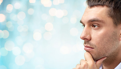 Image showing close up of male face over blue lights background