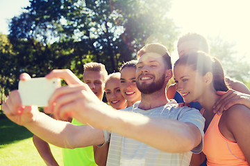 Image showing happy friends taking selfie with smartphone