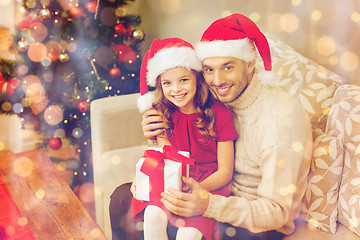 Image showing smiling father and daughter holding gift box