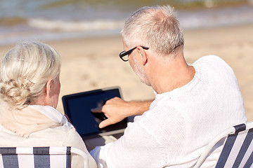 Image showing close up of senior couple with tablet pc on beach