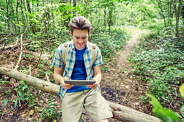 Image showing happy man with backpack and tablet pc in woods