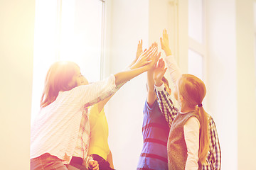 Image showing group of school kids making high five gesture