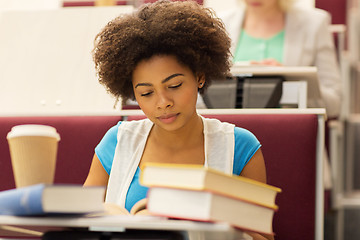 Image showing student girl with books and coffee on lecture