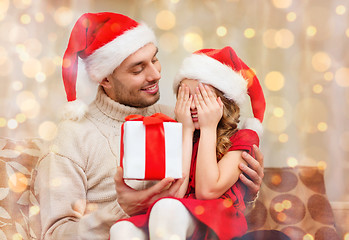 Image showing smiling daughter waiting for a present from father