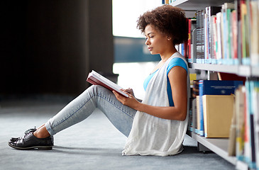 Image showing african student girl reading book at library