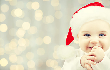 Image showing happy baby in santa hat over holidays lights